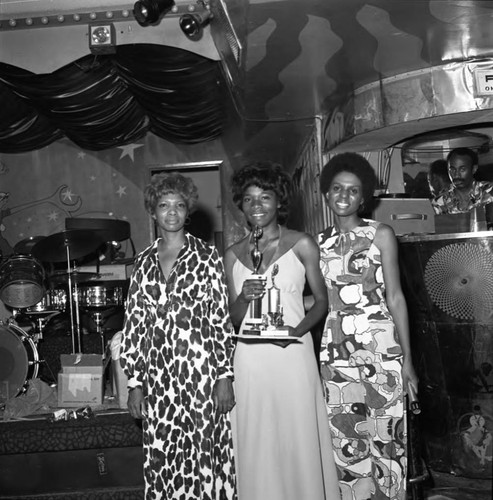 Lynette Hewette Griffin posing with two women at a club, Los Angeles