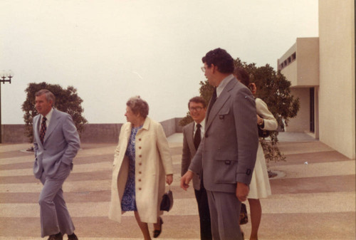 Dean Jerry Hudson, Mrs. Phillips, George Hill, and Dr. Larry Hornbaker walking toward Elkins Auditorium