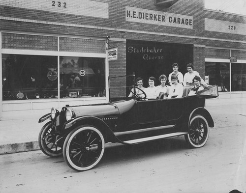 Studebaker Six automobile with young women parked in front of H.E. Hierker Garage, Orange, California, 1920
