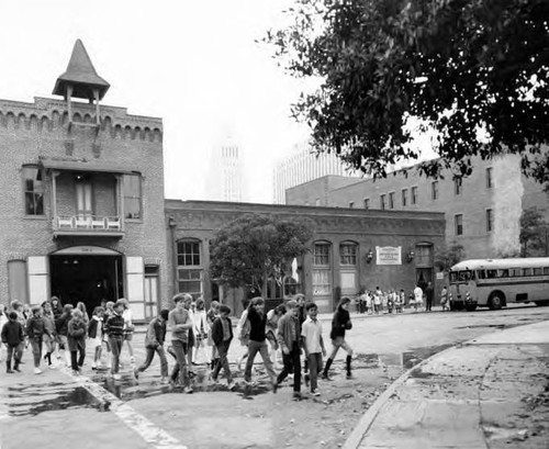 Children in front of the firehouse walking towards the Plaza