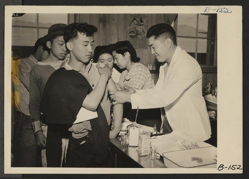 Manzanar, Calif.--Newcomers are vaccinated by evacuee nurses and doctors upon arrival at War Relocation Authority centers for evacuees of Japanese ancestry. Photographer: Albers, Clem Manzanar, California