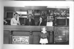 Delbert Triggs, Raymond Smith, Mrs. Georgia Triggs and daughter at the J. F. Triggs & Son Auto parts store at 130 South Main Street Sebastopol, California, 1939