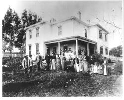 Peoples family photograph taken in front of their house, 1880s