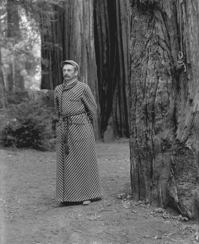 Man wearing robe and cap, Bohemian Grove. [negative]