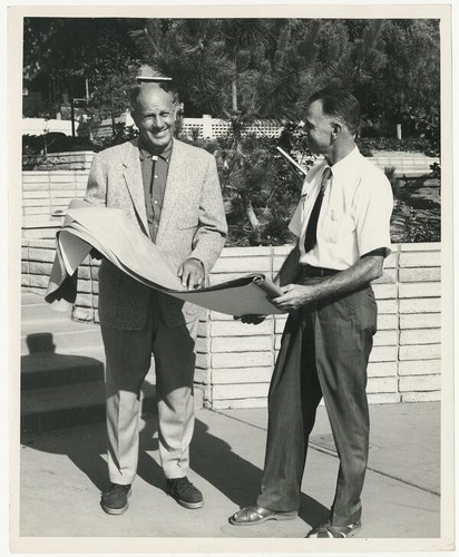 [Arthur Barton (left) holding drawing plans]