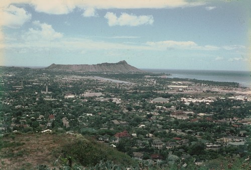 A panoramic view of Honolulu, Hawaii, and the Oahu coastline from a nearby hill top. This photo was taken by a member of the scientific party while taking a break during the Midpac Expedition (1950). 1950