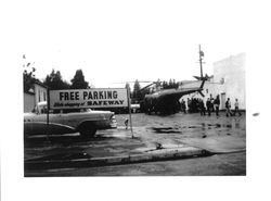 Helicopter in the Safeway parking lot to air lift people during a flood, Guerneville, California, 1955