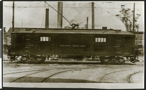 Pacific Electric railway car sitting on tracks near buildings, ca.1912