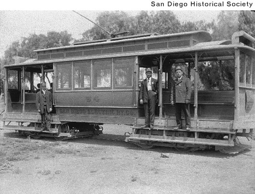 Three men standing on a San Diego Electric Railway streetcar