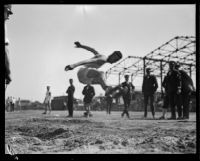 Pacific Fleet athlete broad jumps during the Fleet's track championship meet, Long Beach, 1922