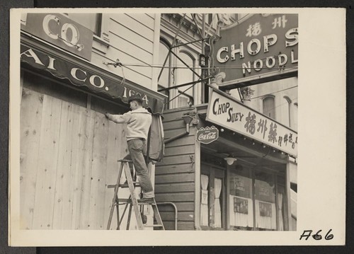 With the owner scheduled to be evacuated, a store front is boarded on Post Street, San Francisco. Evacuees will be housed in War Relocation Authority centers for duration. Photographer: Lange, Dorothea San Francisco, California