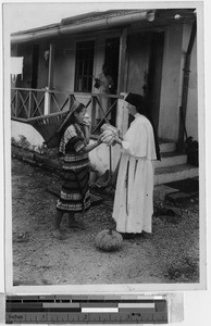 Maryknoll Sister Isabel bargaining with an Igorot woman, Baguio, Philippines, ca.1930-1940