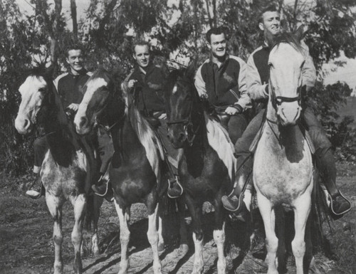 Pepperdine College football players pose on horseback, 1947
