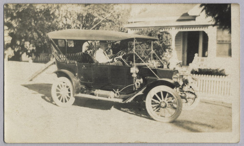 Charlie Baer in vehicle [ca. 1920]