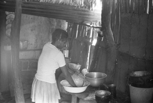 Woman washing a pot, San Basilio de Palenque, 1976