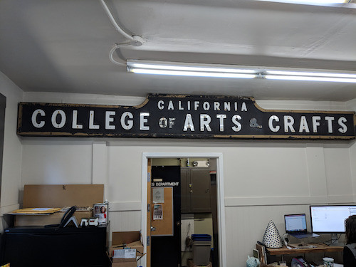 CCAC Broadway entrance gate arch sign, hanging in Facilities Office