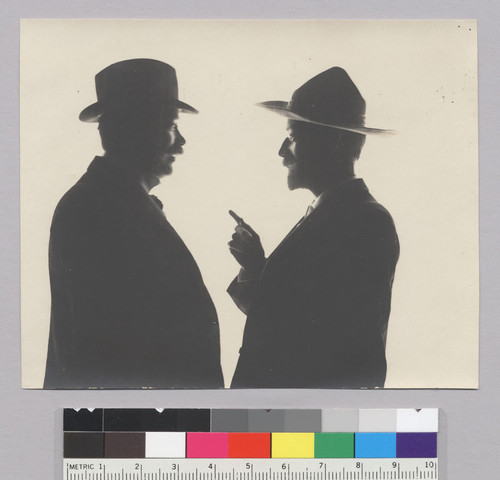 Waist length silhouette of two men conversing, Bohemian Grove. [photographic print]