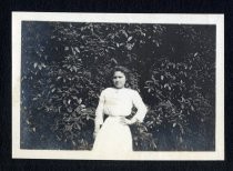 Woman posing in front of ivy tree