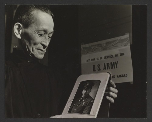 [Man holding photo of son in U.S. Army, Frank Nakako]