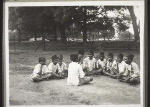 Boys of the orphanage listening to someone telling a story
