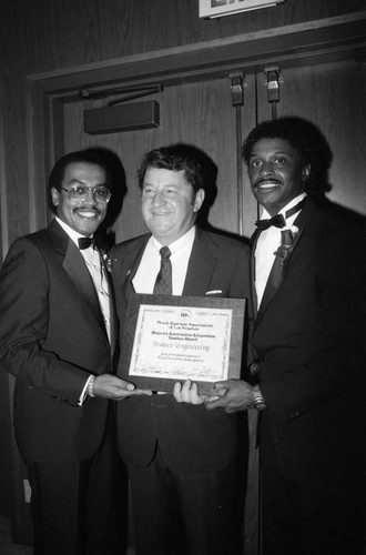 Black Business Association members presenting an award, Los Angeles, 1985