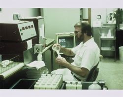 Dick Phillips working in the lab at the California Cooperative Creamery on Western Avenue, Petaluma, California, 1984
