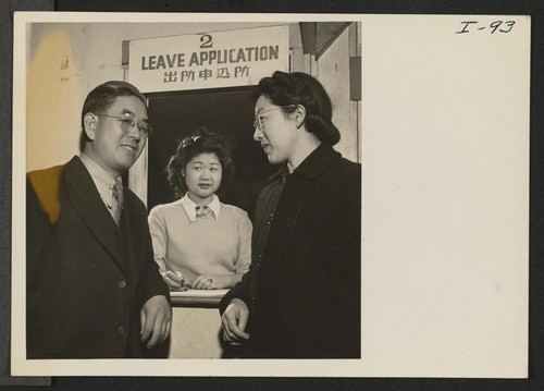 Asako Nomura, of the Leave Application Department, is helping Mr. and Mrs. Thomas T. Sashihara file their applications for indefinite