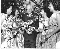 Former San Francisco Mayor Robert Lapman is surrounded by several Analy High School girls who are presenting him with spray of early Gravenstein apple blossoms in preparation for Sebastopol's first celebration of "Apple Blossom Time" in 1947