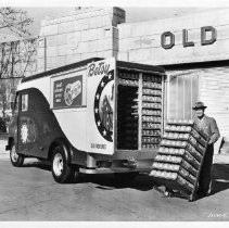 Exterior view of the Old Home Bakers company makers of Old Home and Betsy Ross Bread with one of their delivery trucks parked in front