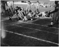Players on the ground during a Polytechnic vs. L.A. High School football game, Los Angeles, September 30, 1937