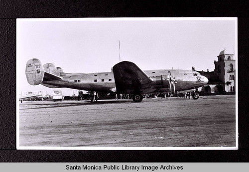 Douglas DC-4E on tarmac with Redman Moving & Storage van (first flight June 6, 1938)