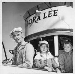 Man with children aboard the Lora Lee in Petaluma, California