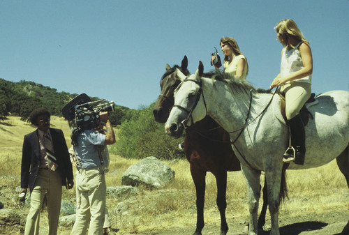 Marin County Department of Open Space District Mounted-Volunteer Patrol Laurie Barnwell (on horse, left), discussing volunteer patrol, Mount Burdell Open Space Preserve, Marin County, 1977 [photograph]
