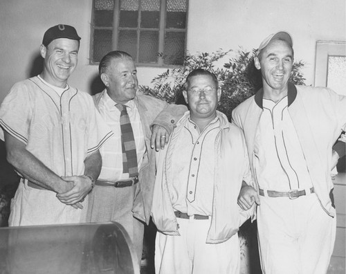 Group portrait of four men, identified as William Sangster, Dr. Paul E. Rumph, Ranald A. Fairbairn, and Dr. [Wilfred?] Leichtfuss, Orange, California, ca. 1950