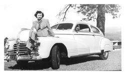 Bunni Cornelia E. Myers Streckfus seated on hood of car at the Sonoma Golf Club, February 1942
