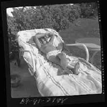 A man lying on a chaise lounge