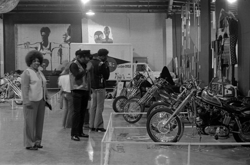 Men and a woman at motorcycle show