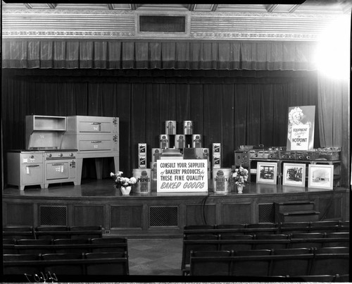 Display of commercial restaurant cooking equipment and food products on the stage the G.O. auditorium