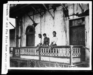 Three women standing on the veranda at the old Pio Pico residence in Whittier, ca.1890
