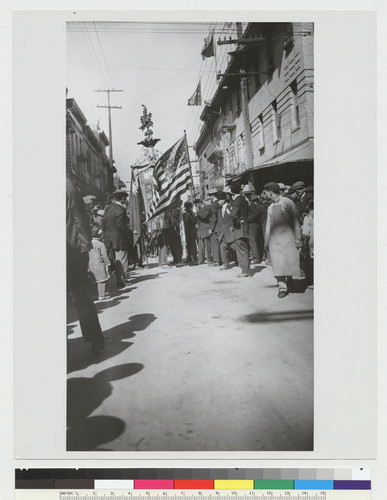 [parade with American and Chinese flags]