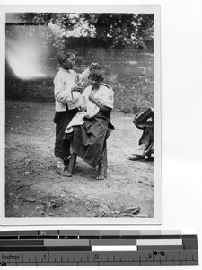 A boy gets a haircut in Siachang, China, 1929