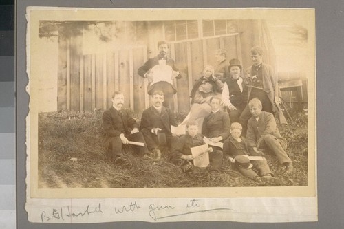 Burnette Haskell with guns, etc. Edwin Wilda Haskell to Burnette's right, wearing top hat. Benjamin B. Haskell seated in front of Burnette. Helen Fader Jones (later Helen F.J. Robinson) seated below and to left of Edwin Wallace Haskell