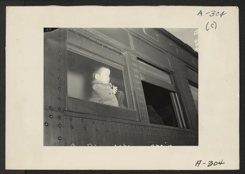 Lone Pine, Calif.--A young evacuee of Japanese ancestry arrives here by train prior to being transferred by bus to Manzanar, now a War Relocation Authority center. Photographer: Albers, Clem Lone Pine, California