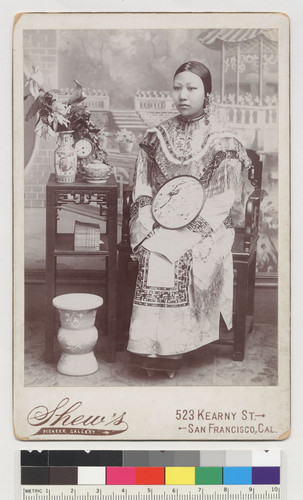 [young woman with fan, seated]