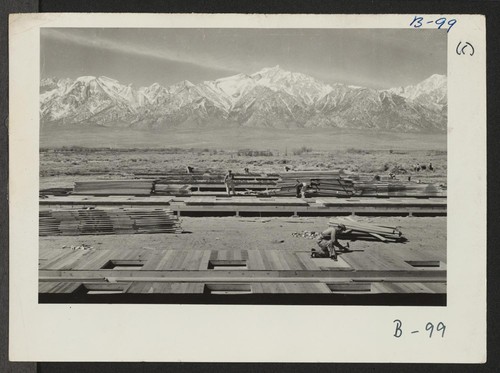 Construction begins at Manzanar, now a War Relocation Authority Center for evacuees of Japanese ancestry, in Owens Valley, flanked by the High Sierras and Mt. Whitney, loftiest peak in the United States. Photographer: Albers, Clem Manzanar, California