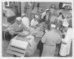 Workers boxing bagged chickens at the California Poultry, Incorporated, Fulton, California, 1958