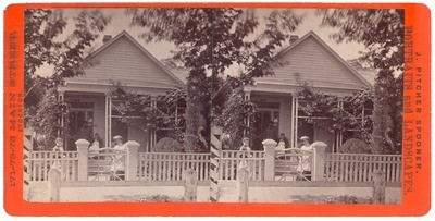 Stockton: (House with two adults, one baby on porch, two people by gate.)