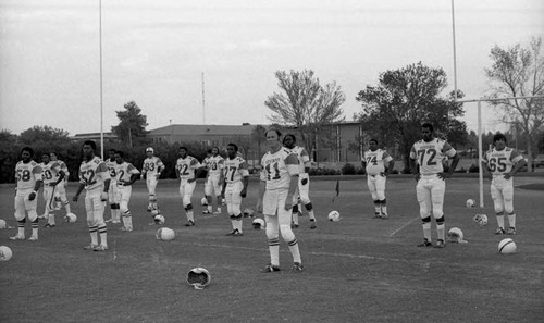 Football team pausing during a practice, Los Angeles