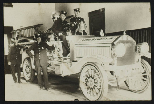 Four unidentified personnel from Engine Co. 3 with a fire truck