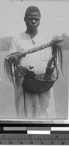 Man holding a harp, Africa, ca. 1920-1940